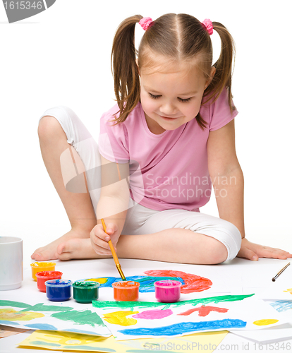 Image of Cute cheerful child play with paints