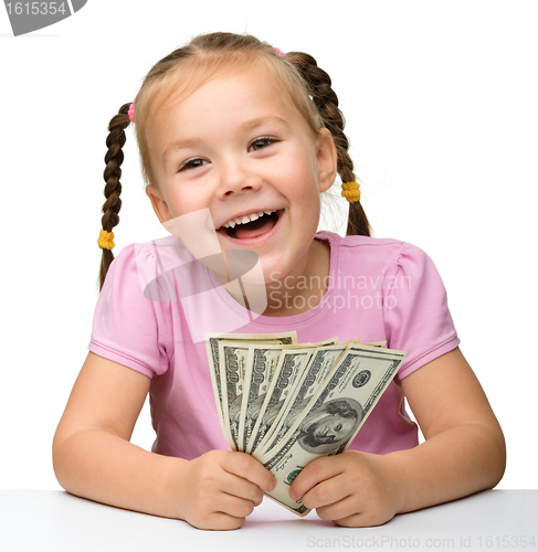 Image of Cute little girl with paper money - dollars