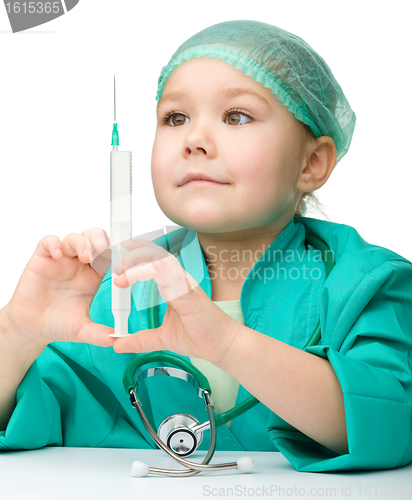 Image of Cute little girl is playing doctor with syringe