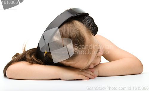 Image of Cute little girl is sleeping in headphones