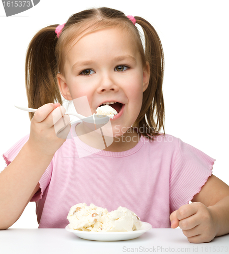 Image of Cute little girl is eating cottage cheese