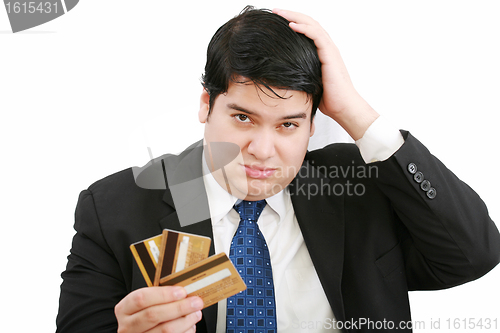 Image of Upset robbed man glaring at his many credit cards.