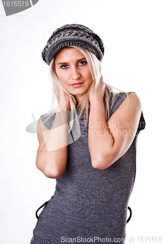 Image of Fashionable young woman in gray sweater and cap, isolated on white background 