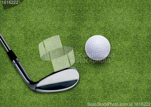 Image of Golf ball and putter on green grass 