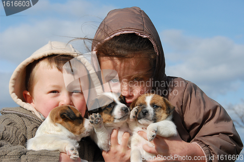 Image of children and puppies