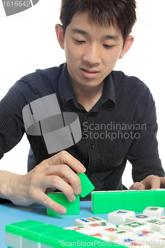 Image of Chinese man play Mahjong, traditional China gamble. 