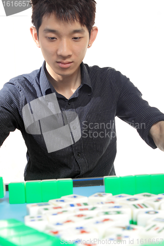 Image of Chinese man play Mahjong, traditional China gamble. 