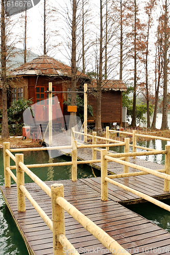 Image of Wood house on lake and path