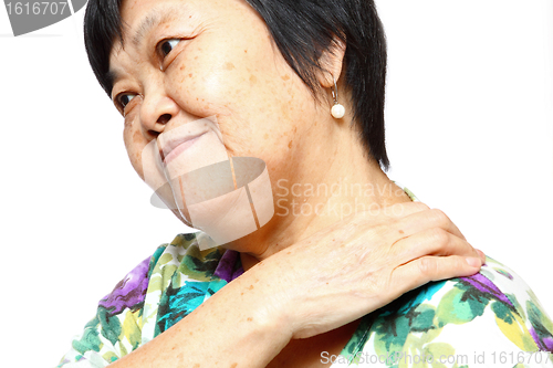 Image of senior woman holding her aching back 