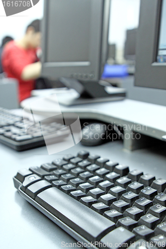 Image of computer room and student studying