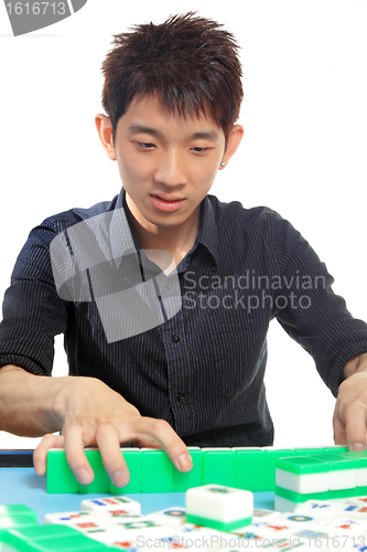 Image of Chinese man play Mahjong, traditional China gamble. 