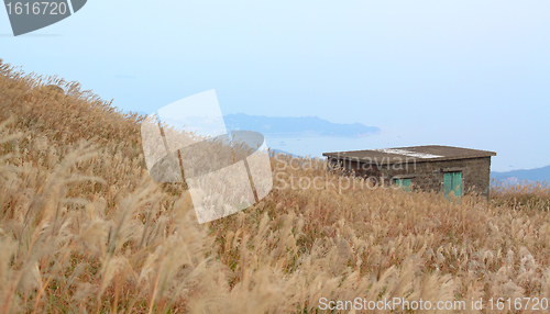 Image of old stone house with grass on the mountain 