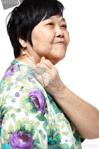 Image of senior woman holding her aching back 