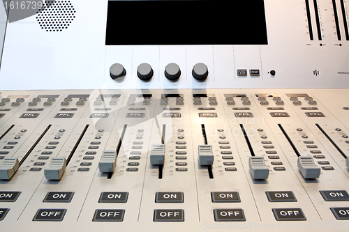 Image of Part of an audio sound mixer with buttons 