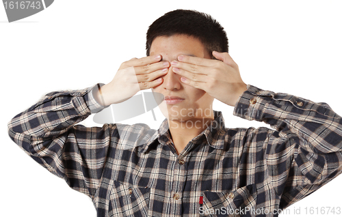 Image of Portrait of a young man covering his eyes with hands 