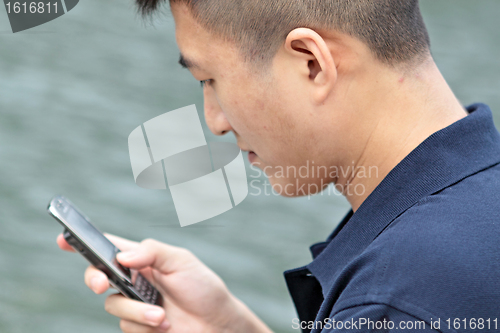 Image of asia man talking on phone