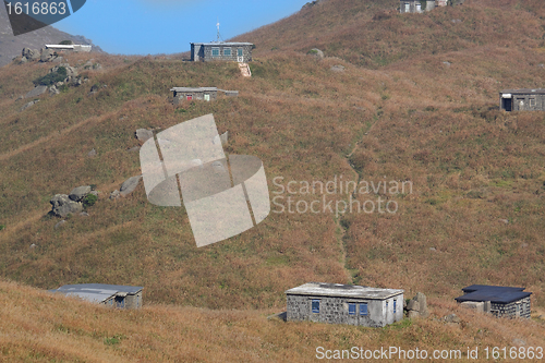 Image of old stone house with grass on the mountain 