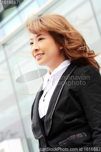 Image of young business woman and an office background