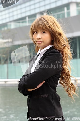 Image of young business woman and an office background