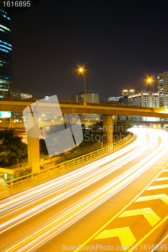 Image of Traffic at night with traces of lights left by the cars on a hig