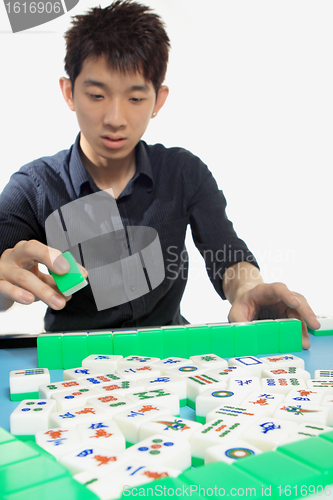 Image of Chinese man play Mahjong, traditional China gamble. 