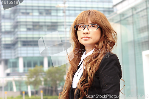 Image of young business woman and an office background