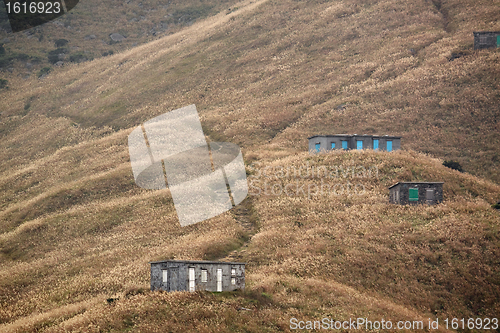 Image of old stone house with grass on the mountain 