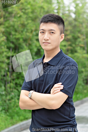 Image of young business man stand and hand cross