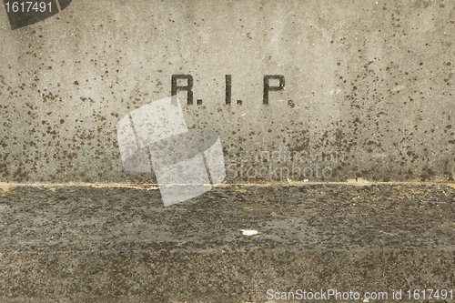 Image of The letters RIP on an old grave