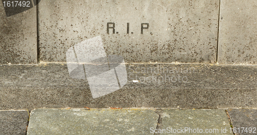 Image of The letters RIP on an old grave