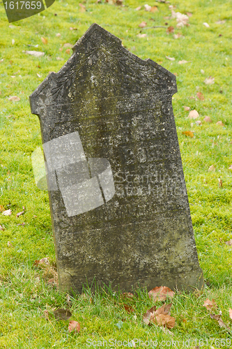 Image of A tombstone on an old graveyard