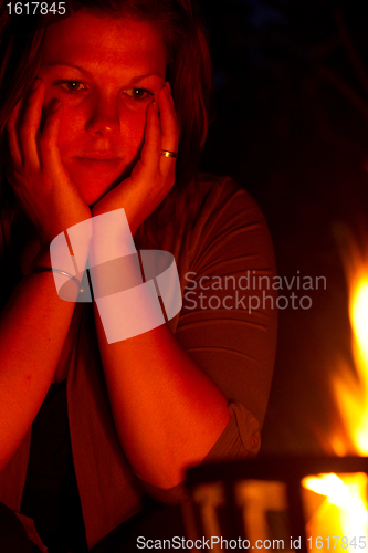 Image of Female is staring into the fire