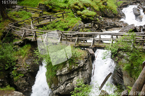 Image of Wooden bridge over Saent waterfalls in the Italian mountains