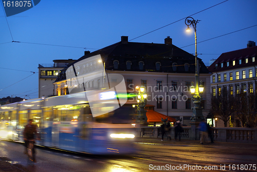 Image of 	Gothenburg at night. Some trams and people in motion