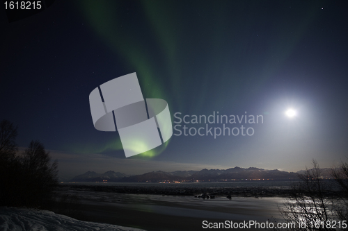 Image of Active Aurora shines through Full Moon Light Over Cook Inlet and