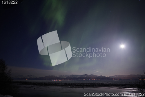 Image of Active Aurora shines through Full Moon Light Over Cook Inlet and