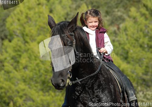Image of little girl and her black horse