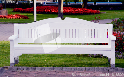 Image of White bench in park.