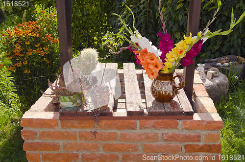 Image of Cacti and flowes in vase.