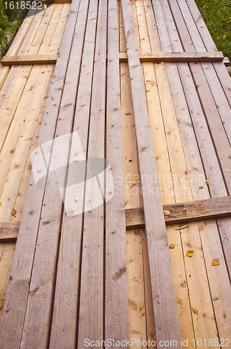 Image of Long wooden planks loaded in a bunch. 