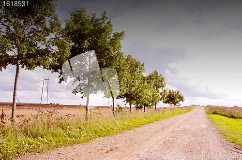 Image of Rural gravel road. High voltage wire.