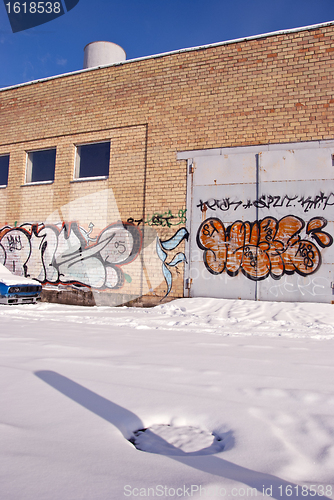 Image of Graffiti on old white brick walls.