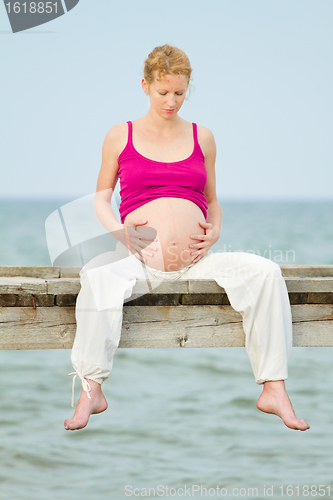 Image of pregnant woman on beach