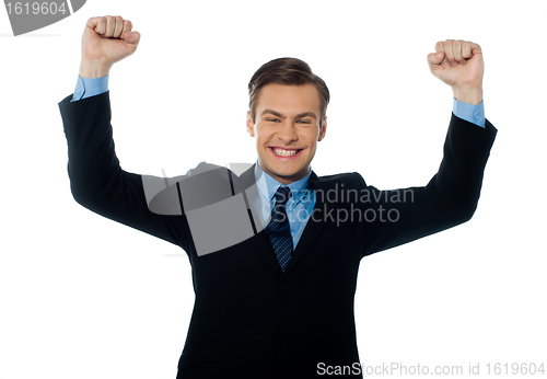 Image of Businessman celebrating success with arms up