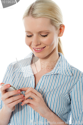 Image of Stylish corporate female texting on phone