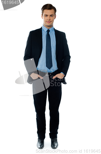 Image of Young businessperson posing with hands in pocket