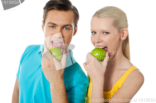 Image of Healthy couple eating fresh green apple