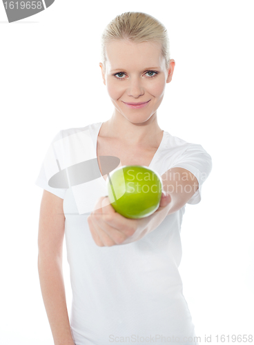 Image of Cute teenager offering green apple