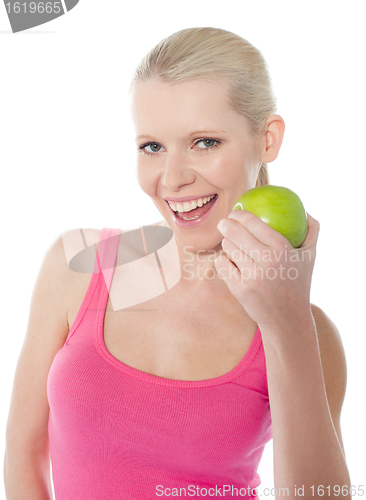 Image of Pretty caucasian girl eating an apple