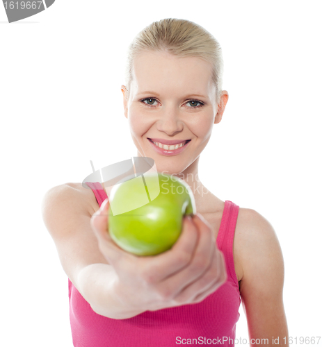 Image of Healthy teenager offering green apple to you